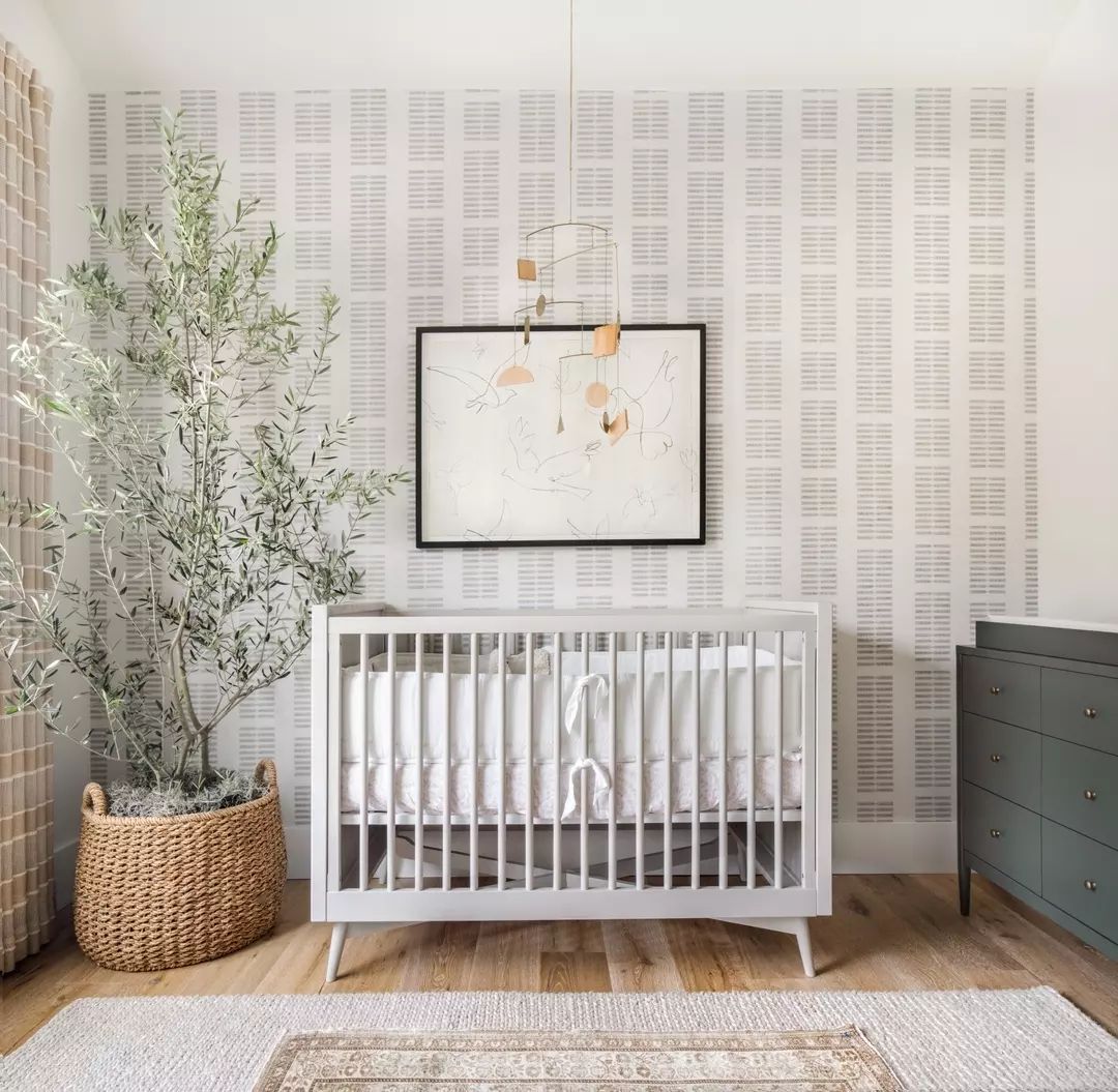 Scandinavian style nursery with large plant and wall art. Photo by Instagram user @lindyegalloway