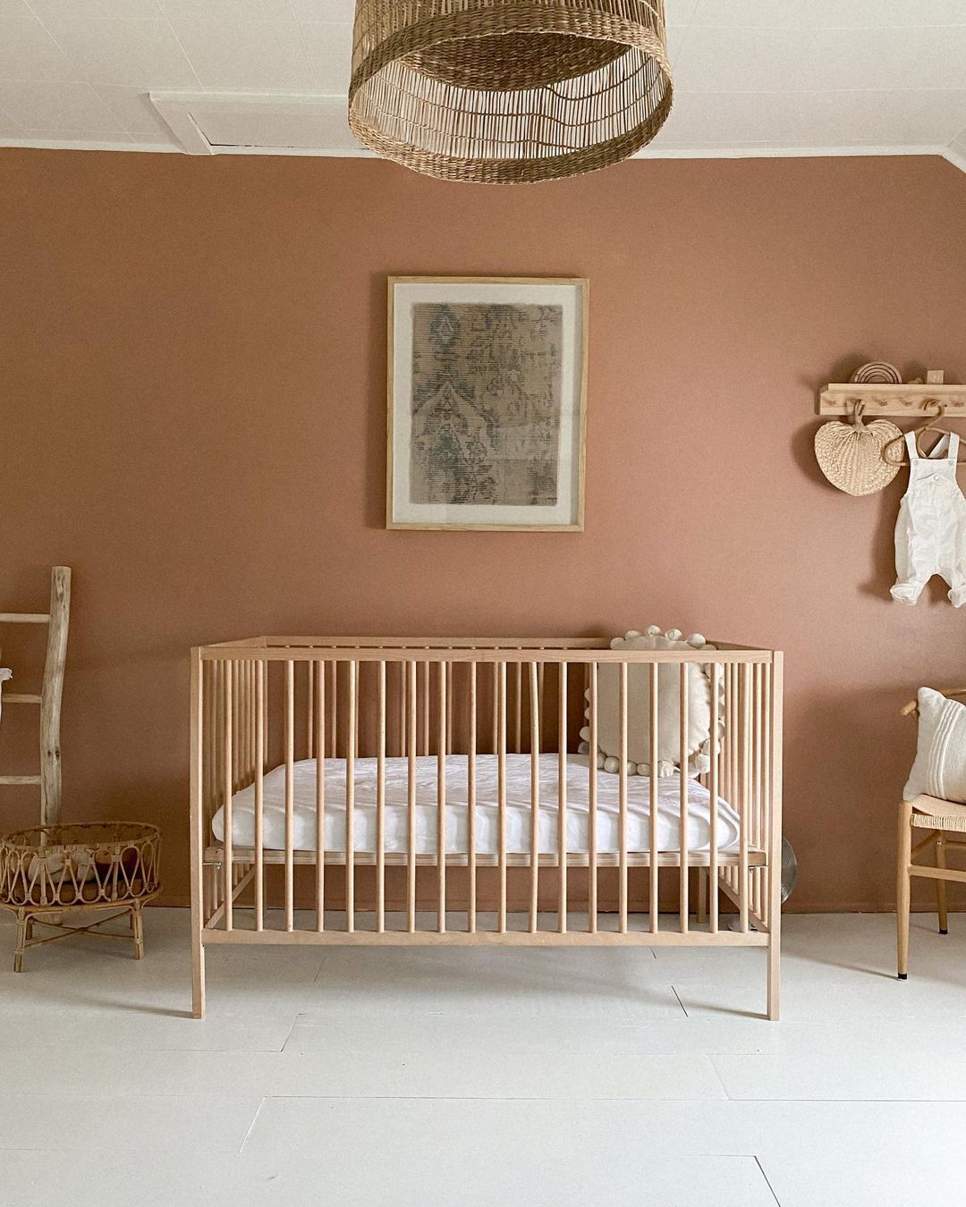 Terra Cotta Nursery with Light Wooden Crib and Wall Art. Photo by Instagram user @jennaborst