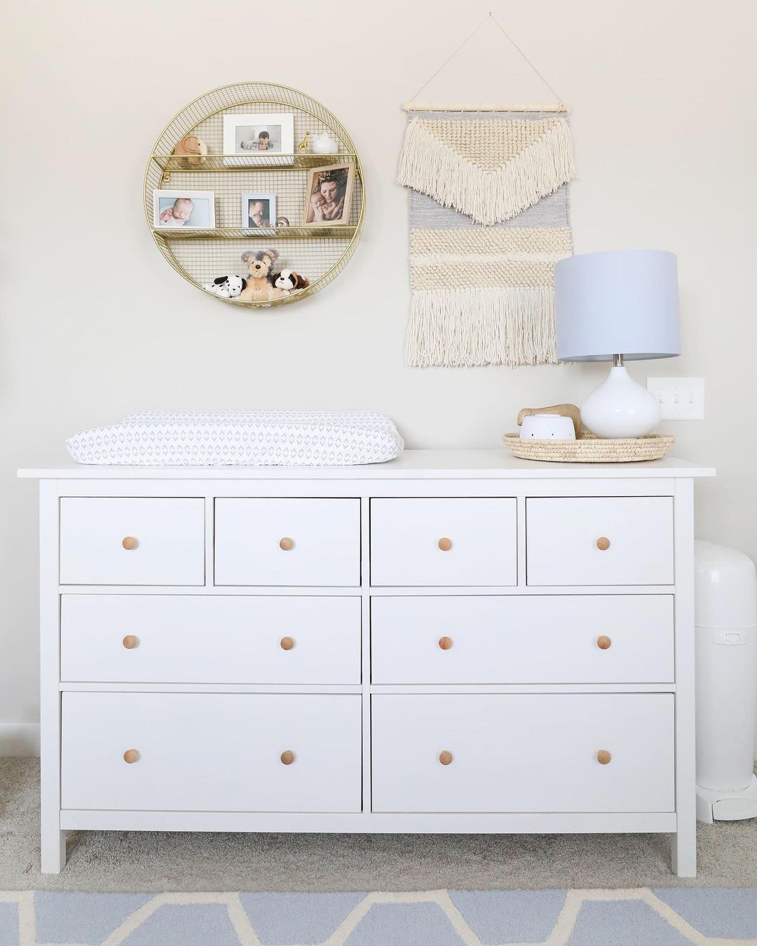 White dresser with changing pad and minimal decor. Photo by Instagram user @twotwentyone