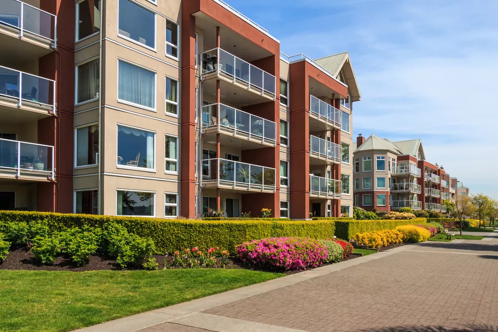 Outside view of a modern apartment complex with landscaping.