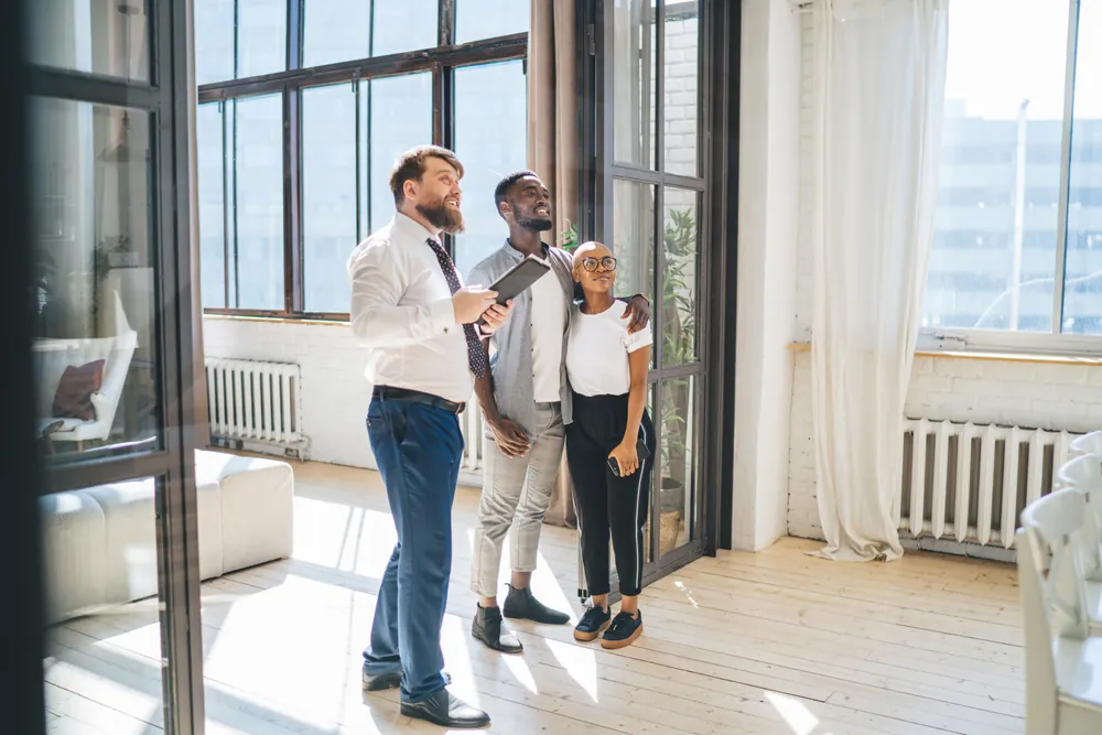 Property manager conducting an apartment tour with a couple.