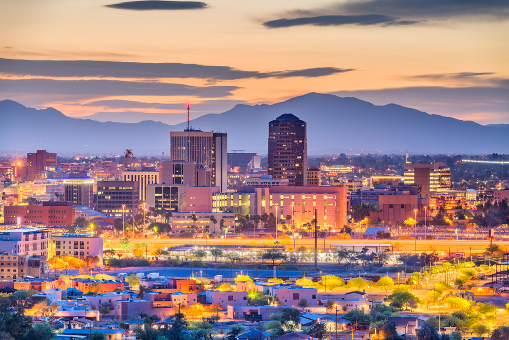 Aerial view of downtown Tucson with mountains in the background.