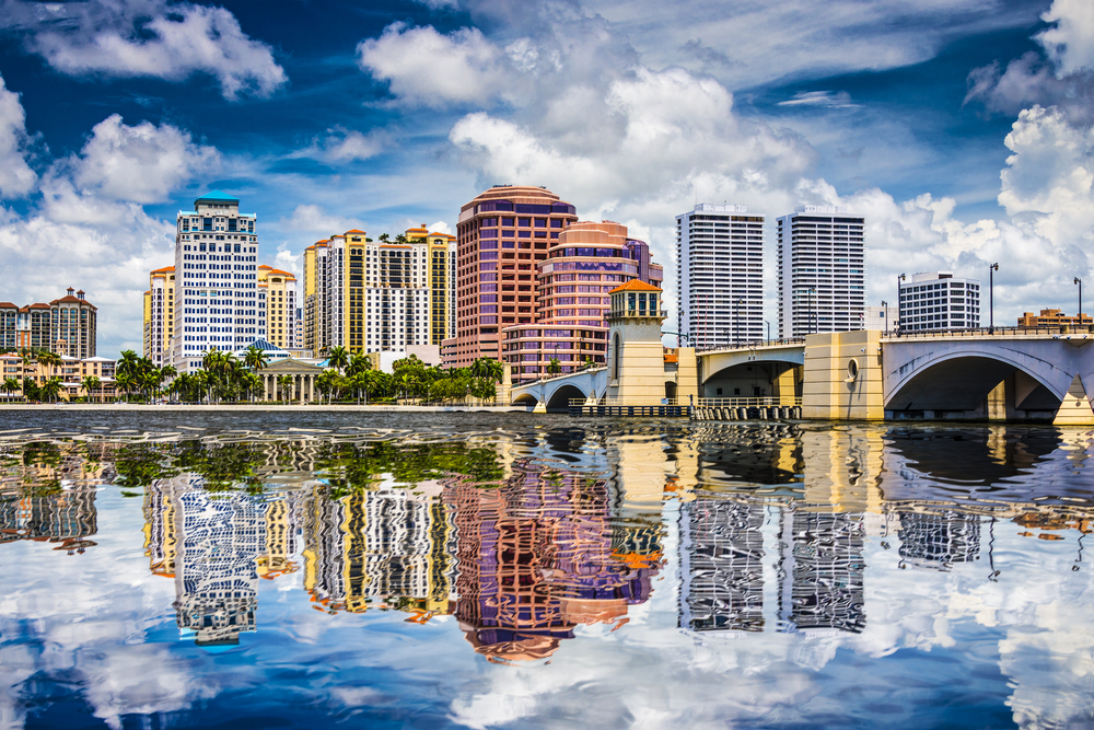 A view of the West Palm Beach skyline over water.