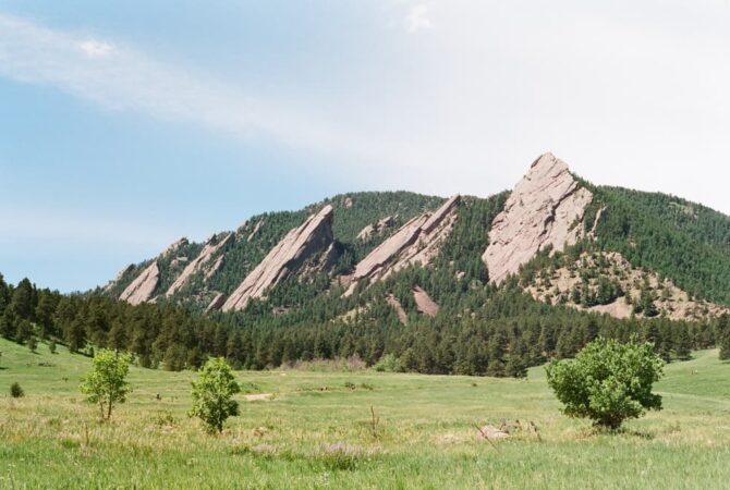 Mountains behind a green field in Boulder, Colorado