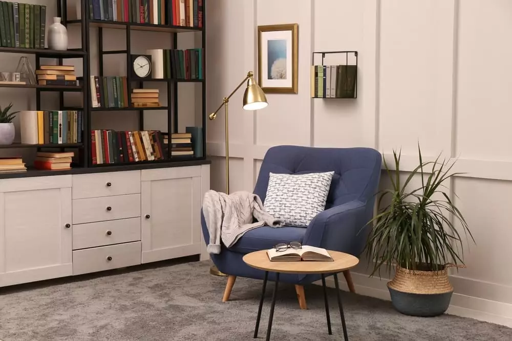 A chair is placed next to a bookshelf.