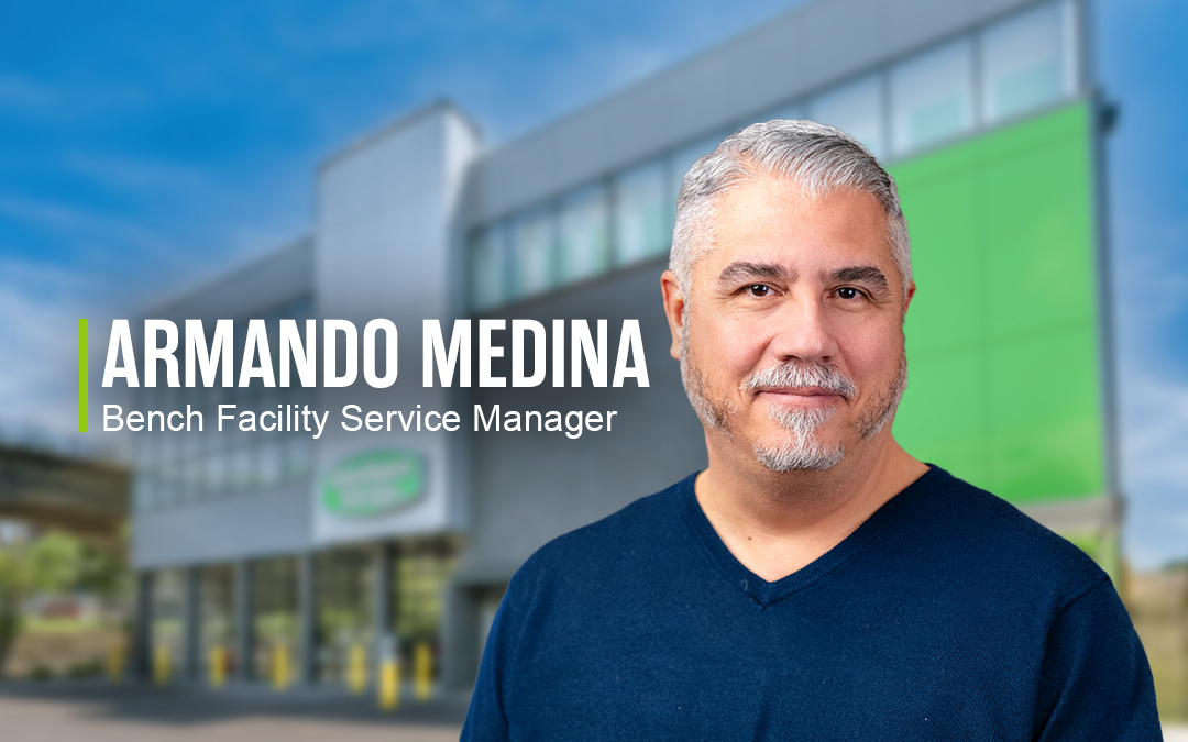 Man with gray hair smiling in front of Extra Space Storage facility with the text "Armando Medina, Bench Facility Service Manager" beside him