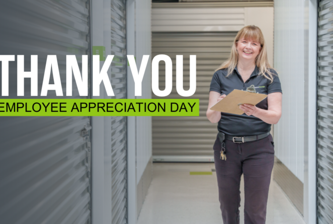 Woman smiling and holding a clipboard inside a self storage facility with text beside her that reads "Thank you Employee Appreciation Day."