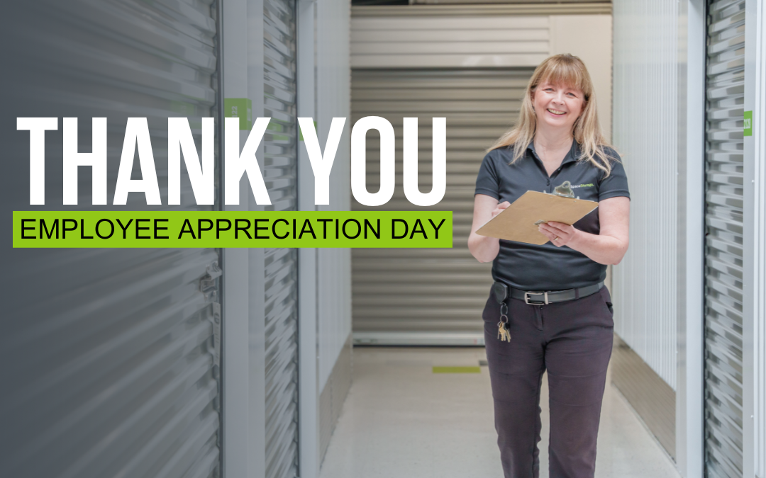 Woman smiling and holding a clipboard inside a self storage facility with text beside her that reads "Thank you Employee Appreciation Day."