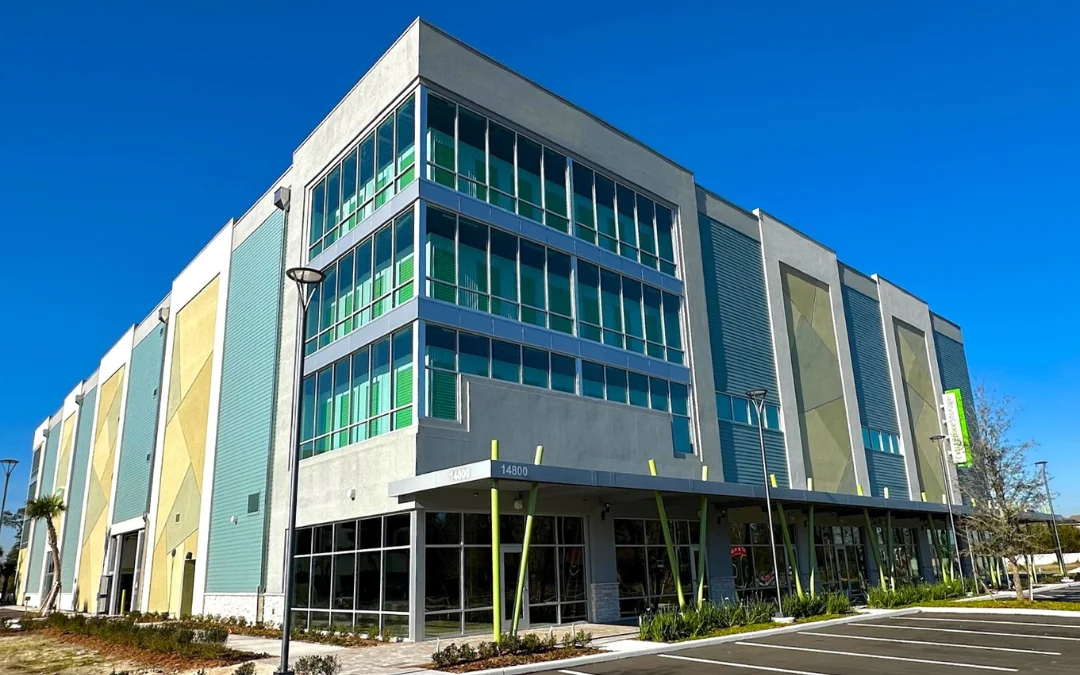 Corner of multi-floor storage facility at 14800 Narcoossee Rd with glass windows on clear day in Orlando, Florida