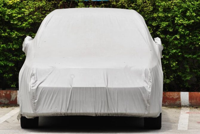 Small car in outdoor parking space with cover for long-term vehicle storage