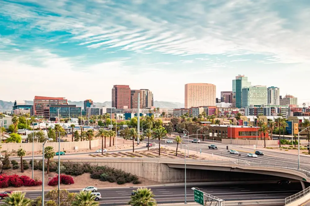 A skyline photo of Phoenix featuring tall buildings and roadways