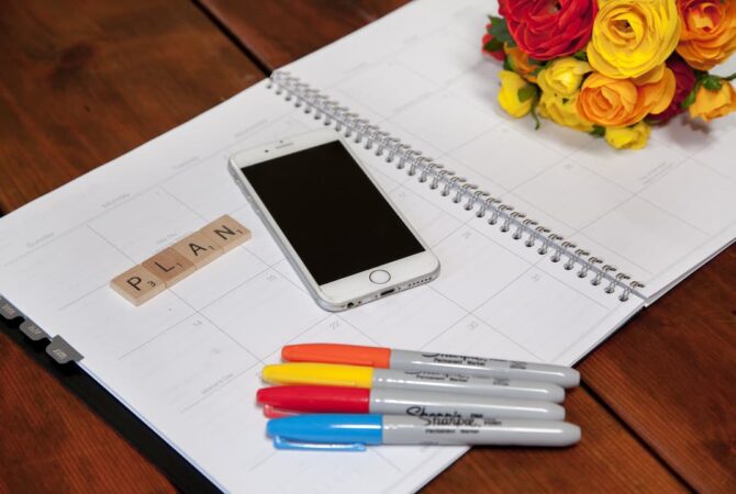 planner with markers and phone