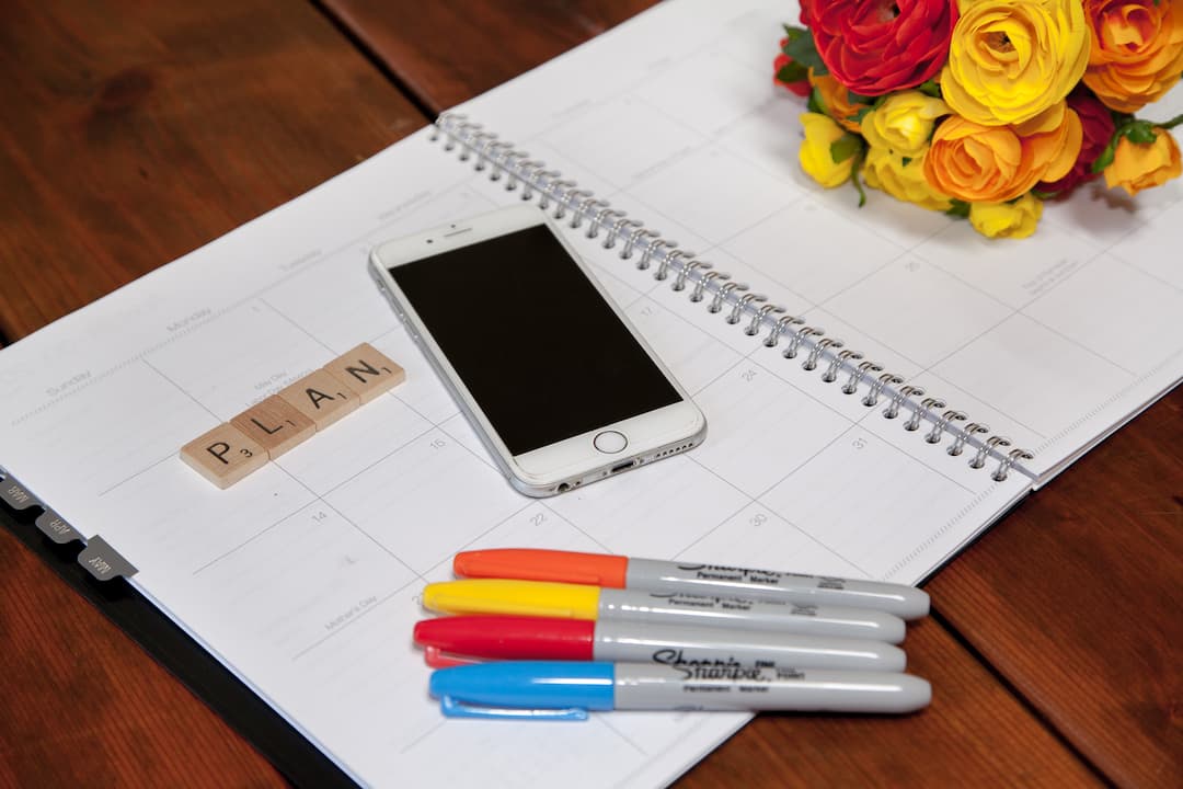 planner with markers and phone