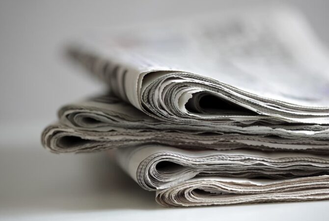 A stack of folded newspapers