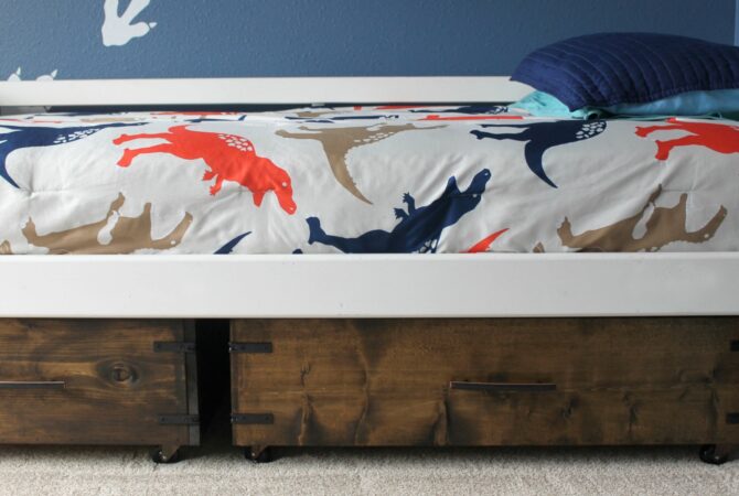 Drawers for storage are tucked under a bed.