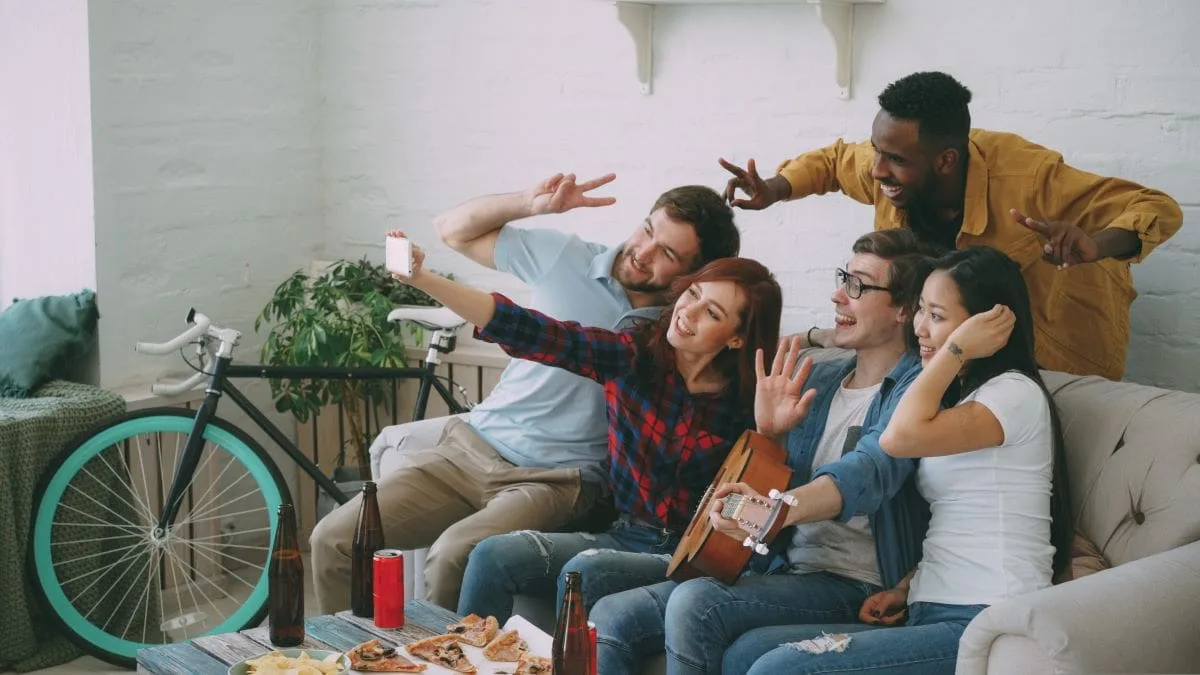 Group of friends taking selfies on a couch