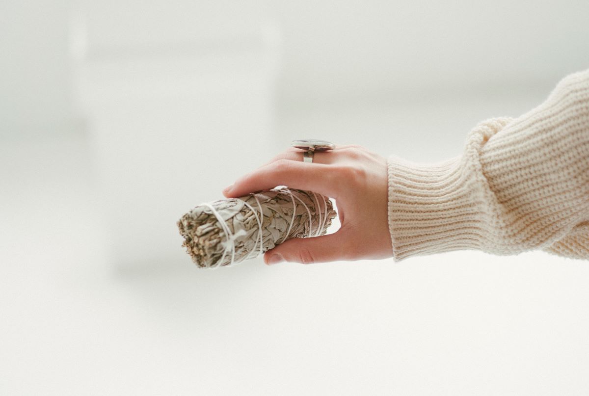 Hand holding a bundle of sage