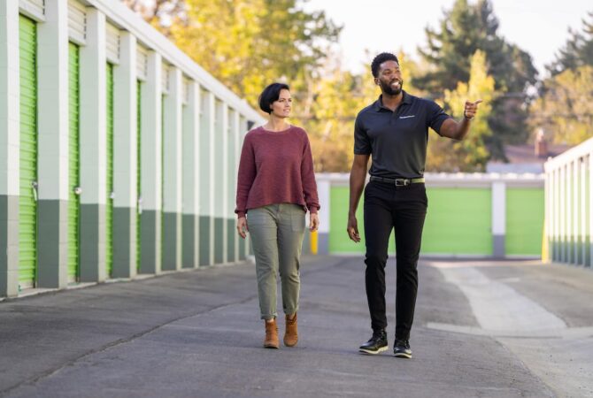 An Extra Space Storage employee walks a customer through drive-up storage units.
