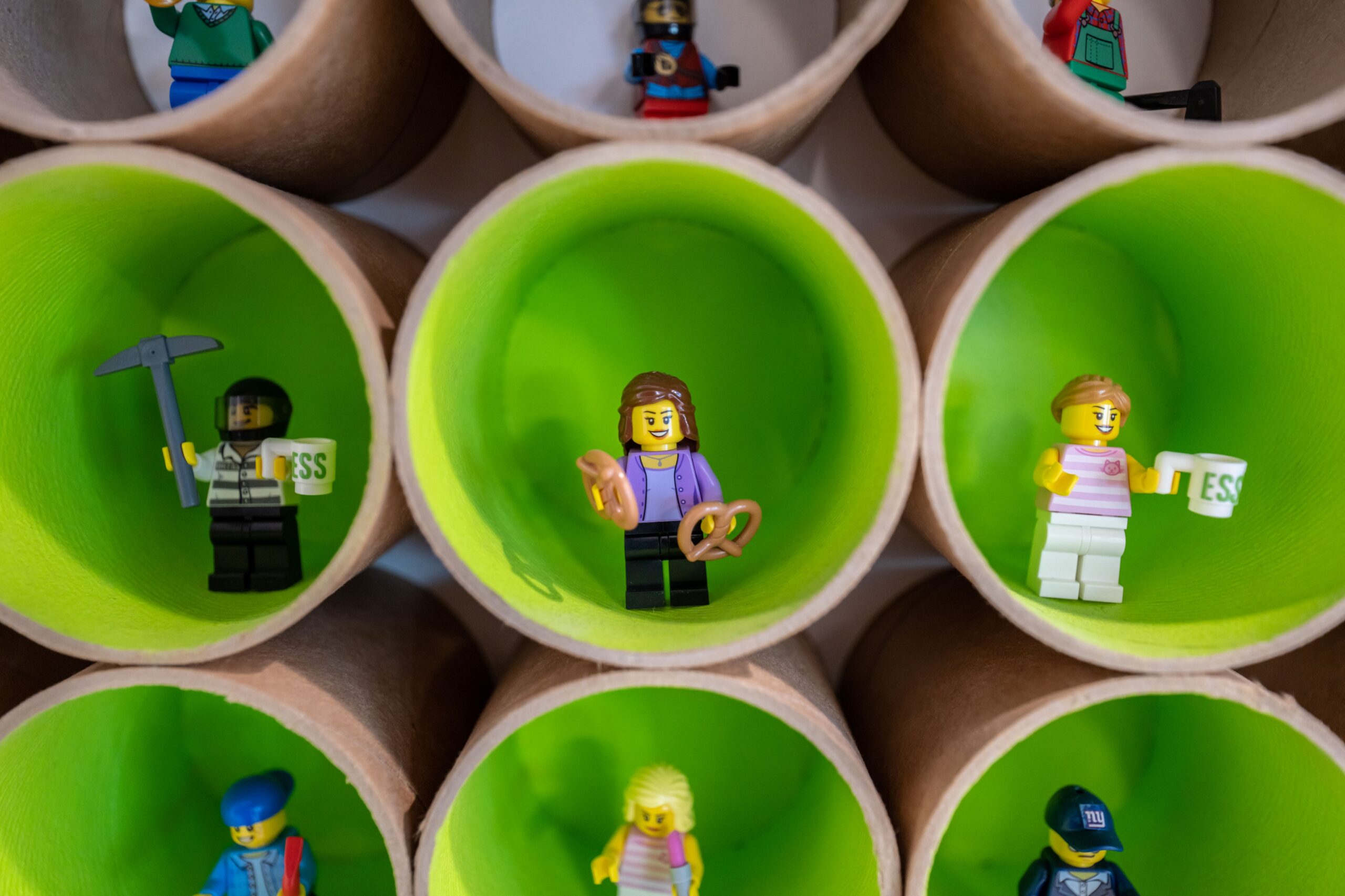 LEGO figurines stand inside bright green circles.