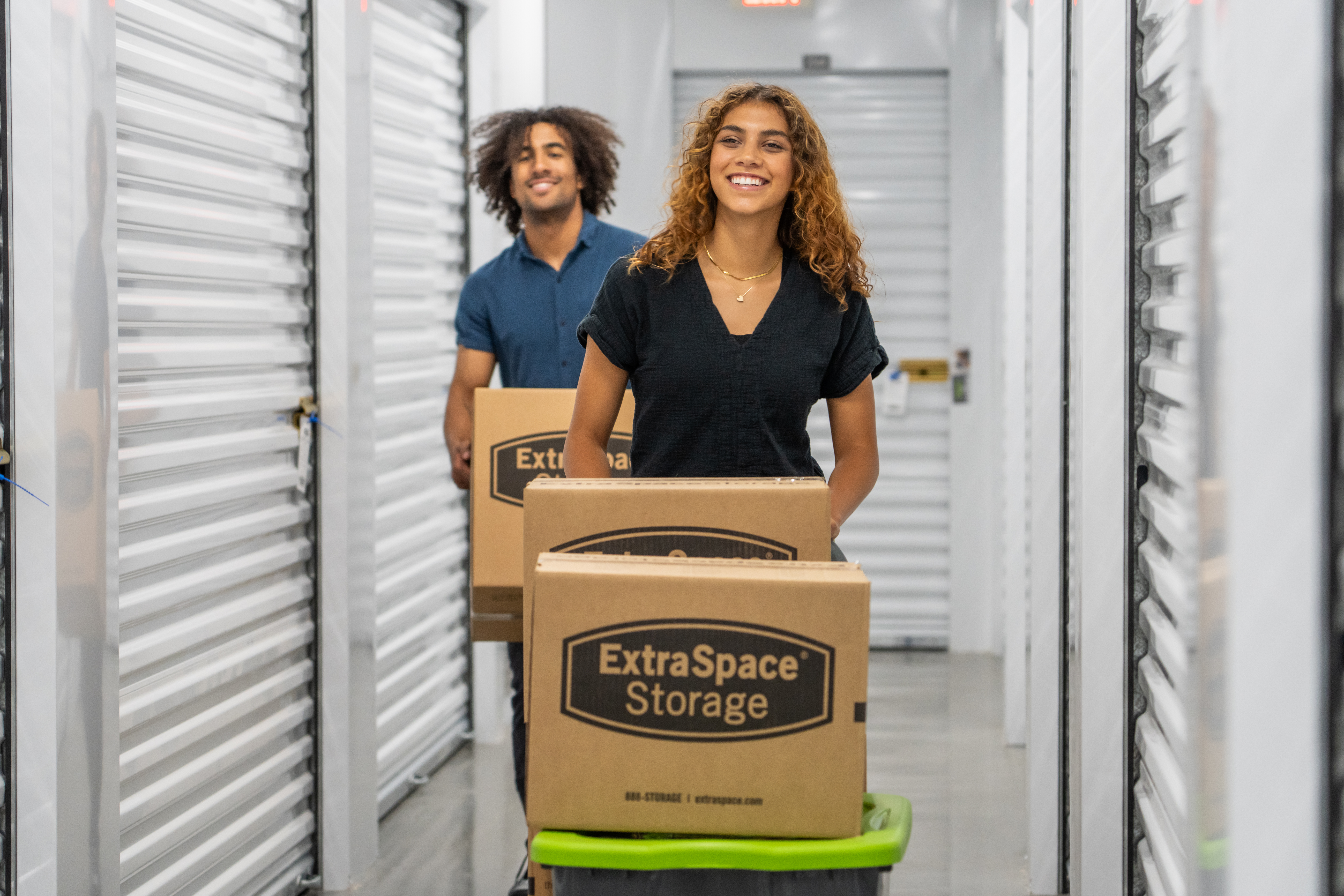 Two people bringing in boxes to pack in a unit at Extra Space Storage