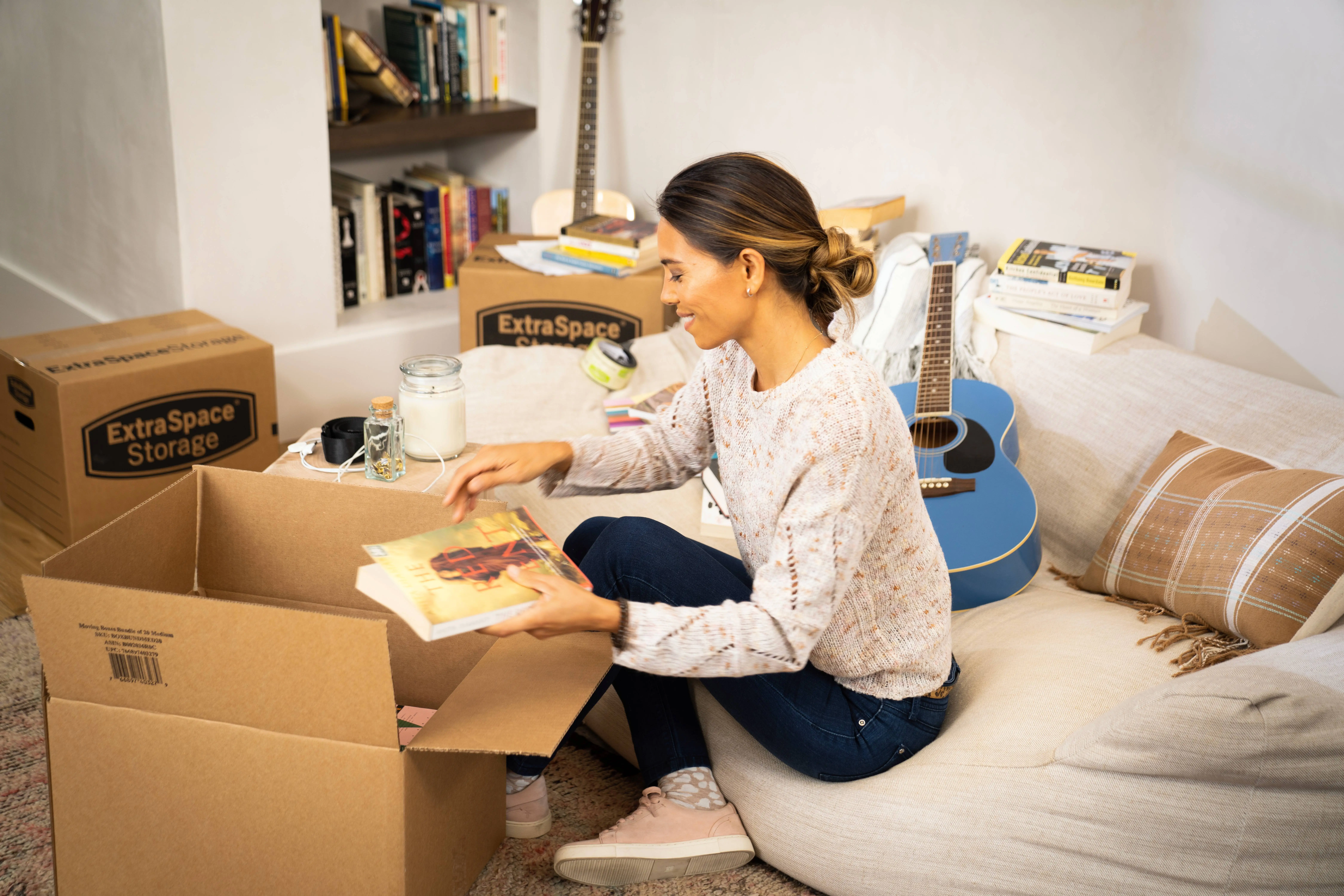 Woman packing items in boxes to put in a storage unit