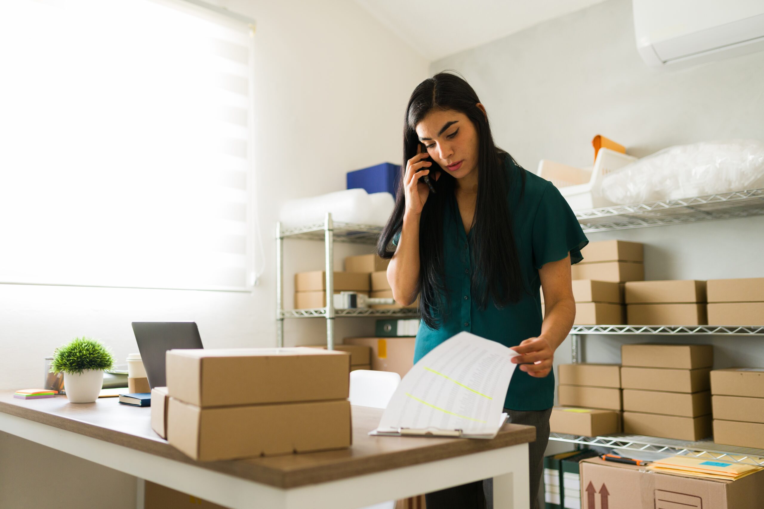 Small business owner on the phone in their home office.